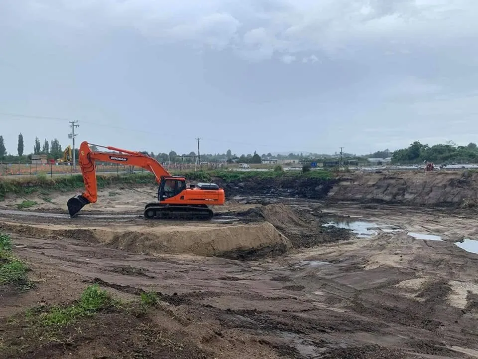 Excavator cutting a bulk earthworks platform