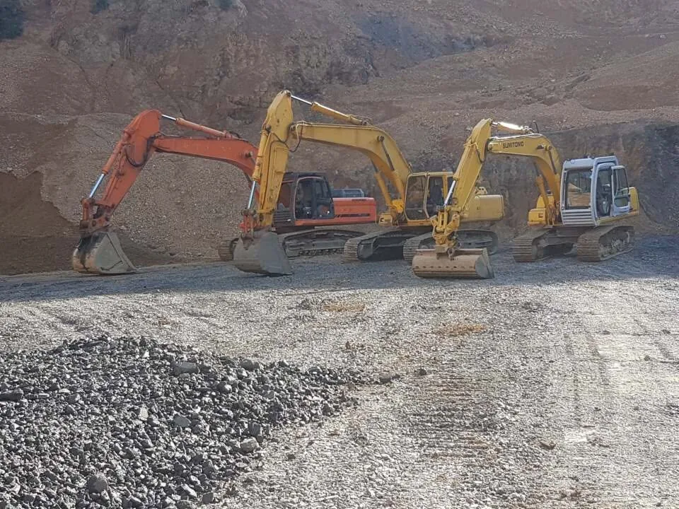 Row of excavators lined up in a quarry