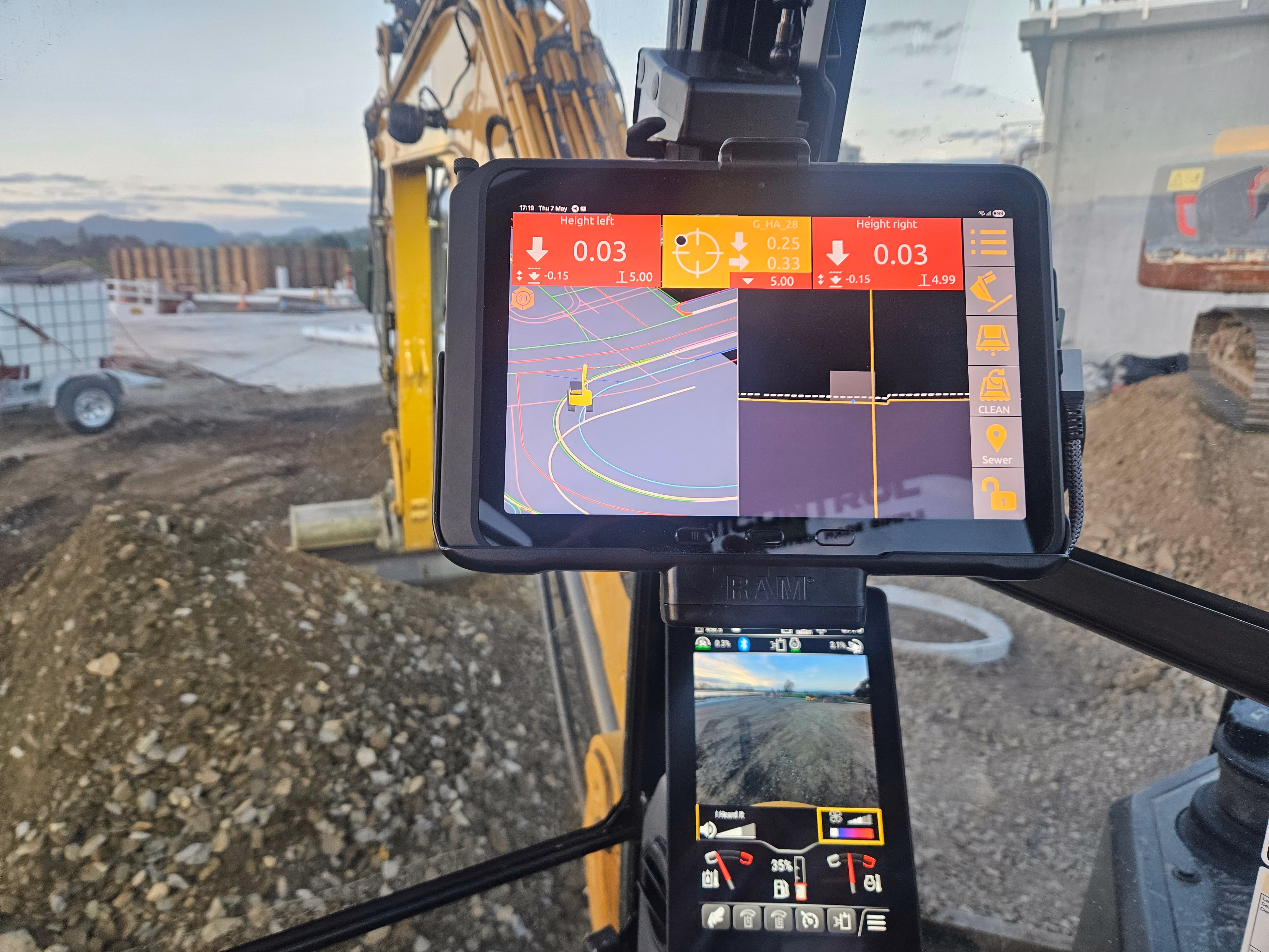 GPS machine control screen inside the excavator cab showing design levels