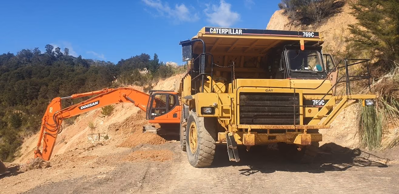 Dump truck working below a quarry face